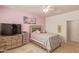 This charming bedroom features a ceiling fan, TV and dresser with drawers for ample storage at 2292 S 236Th Dr, Buckeye, AZ 85326