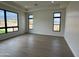 Bedroom with hardwood floors and multiple windows offering natural light and neighborhood views at 23964 N 128Th Pl, Scottsdale, AZ 85255