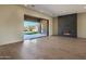 Open-concept living room with modern fireplace and access to the outdoor living space at 23964 N 128Th Pl, Scottsdale, AZ 85255
