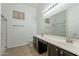 Bright bathroom with double sinks, a large mirror, and a tiled floor at 2444 S Terrell --, Mesa, AZ 85209