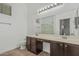 Bathroom with double vanity, large mirror, shower with glass door and tile floors at 2444 S Terrell --, Mesa, AZ 85209