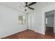 Bedroom with hardwood floors, ceiling fan, closet with sliding door, and neutral color palette at 2444 S Terrell --, Mesa, AZ 85209
