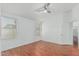 Well-lit bedroom with hardwood floors, ceiling fan, and ample natural light through large windows at 2444 S Terrell --, Mesa, AZ 85209