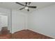Bedroom with hardwood floors, ceiling fan, closet with sliding door, and neutral color palette at 2444 S Terrell --, Mesa, AZ 85209
