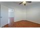 Bedroom with ceiling fan, wood-look flooring and view to a hallway at 2444 S Terrell --, Mesa, AZ 85209
