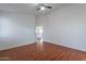 Inviting bedroom with wood floors, a ceiling fan, and a view through to the kitchen at 2444 S Terrell --, Mesa, AZ 85209