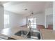 Bright, open floor plan with a kitchen island and stainless steel sink, perfect for entertaining guests at 2444 S Terrell --, Mesa, AZ 85209