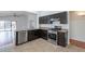 Well-equipped kitchen featuring stainless steel appliances, dark cabinetry, and tile flooring at 2444 S Terrell --, Mesa, AZ 85209