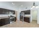 Stylish kitchen featuring stainless steel appliances, tile flooring, dark cabinets, and lots of counter space at 2444 S Terrell --, Mesa, AZ 85209