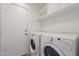 Bright laundry room with washer, dryer, and ample shelving at 2444 S Terrell --, Mesa, AZ 85209