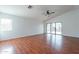 Open-concept living room with wood floors, vaulted ceilings, and sliding glass doors to the backyard at 2444 S Terrell --, Mesa, AZ 85209