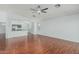 Inviting living space with hardwood floors, ceiling fan and an open layout leading into the adjacent kitchen at 2444 S Terrell --, Mesa, AZ 85209