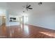 Cozy living room with hardwood flooring, neutral walls, ceiling fan, and an open layout to the kitchen at 2444 S Terrell --, Mesa, AZ 85209