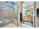 Bright bathroom with a glass-enclosed shower, a convenient bench, and a seamless transition to the vanity area at 26761 W Escuda Dr, Buckeye, AZ 85396