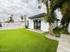 Backyard showcasing an immaculate lawn and modern exterior of the home at 3106 N Valencia Ln, Phoenix, AZ 85018