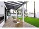 Backyard patio with outdoor seating, a pergola, and a view of a pool and lush green lawn at 3106 N Valencia Ln, Phoenix, AZ 85018