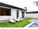 Modern backyard features a pool, artificial turf, and lounge chairs for stylish outdoor living at 3106 N Valencia Ln, Phoenix, AZ 85018