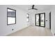 Bright bedroom with light wood floors, large windows, and a door to the outdoor space at 3106 N Valencia Ln, Phoenix, AZ 85018