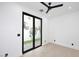 Minimalist bedroom with light wood floors and sliding glass doors to a private outdoor area at 3106 N Valencia Ln, Phoenix, AZ 85018