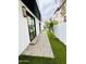 Exterior view of home showcasing a walkway of pavers next to the artificial turf at 3106 N Valencia Ln, Phoenix, AZ 85018