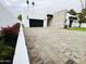 Contemporary home featuring a unique stone accent wall and a patterned brick driveway at 3106 N Valencia Ln, Phoenix, AZ 85018