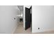 Hallway with white walls and light flooring leading to a modern bathroom at 3106 N Valencia Ln, Phoenix, AZ 85018