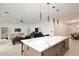 Open-concept kitchen with marble island and modern design adjacent to the living area at 3106 N Valencia Ln, Phoenix, AZ 85018