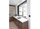 Bright kitchen featuring a marble countertop, sleek cabinets, and a large window to the outdoor patio at 3106 N Valencia Ln, Phoenix, AZ 85018