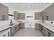 Spacious laundry room with gray cabinets, white countertops, and modern fixtures at 3106 N Valencia Ln, Phoenix, AZ 85018