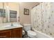 This bathroom has tile floors, a shower/tub combo and a framed mirror at 36579 W Barcelona Ln, Maricopa, AZ 85138