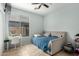This bedroom features tile floors, a ceiling fan and a large window with a view to the exterior at 36579 W Barcelona Ln, Maricopa, AZ 85138