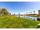 Scenic pond in a well-maintained green space; a serene spot for relaxation and enjoying nature at 36579 W Barcelona Ln, Maricopa, AZ 85138