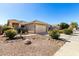 Charming home with a desert landscaped front yard with a two car garage at 36579 W Barcelona Ln, Maricopa, AZ 85138