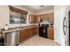 A cozy kitchen features brown cabinetry and essential stainless steel dishwasher at 36579 W Barcelona Ln, Maricopa, AZ 85138