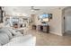 The living room offers an open concept with neutral paint, tile flooring, and modern decor at 36579 W Barcelona Ln, Maricopa, AZ 85138