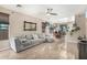 The living room offers an open concept with neutral paint, tile flooring, and comfortable seating at 36579 W Barcelona Ln, Maricopa, AZ 85138