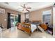 Spacious main bedroom with a ceiling fan and sliding glass doors leading to the pool at 36579 W Barcelona Ln, Maricopa, AZ 85138