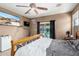 Spacious main bedroom with a ceiling fan and sliding glass doors leading to the pool at 36579 W Barcelona Ln, Maricopa, AZ 85138