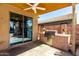 The outdoor kitchen features a gas grill and built in counterspace at 36579 W Barcelona Ln, Maricopa, AZ 85138
