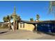 Charming single-story home with a desert landscaped yard, and blue garage door at 3810 W Belmont Ave, Phoenix, AZ 85051