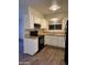 Functional kitchen with sleek black appliances, bright white cabinets, and modern flooring at 3810 W Belmont Ave, Phoenix, AZ 85051