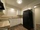 Well-organized kitchen with white cabinets, black appliances, and dark wood flooring at 3810 W Belmont Ave, Phoenix, AZ 85051