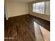 Bright living room with a large window and modern flooring at 3810 W Belmont Ave, Phoenix, AZ 85051