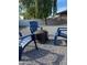 Backyard has gravel, fire pit and chairs for outdoor enjoyment at 4007 W Rue De Lamour Ave, Phoenix, AZ 85029