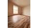 Bedroom with wood floors and natural light from window at 4007 W Rue De Lamour Ave, Phoenix, AZ 85029