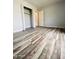 Bright bedroom boasts wood-look floors and closet with ample storage at 4007 W Rue De Lamour Ave, Phoenix, AZ 85029