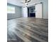Bedroom boasts wood-look floors, ceiling fan, and sliding barn door to bathroom at 4007 W Rue De Lamour Ave, Phoenix, AZ 85029