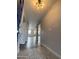 Open entryway with modern lighting and views to living spaces at 4007 W Rue De Lamour Ave, Phoenix, AZ 85029
