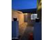Night shot of charming entryway highlighting stylish blue door and decorative planters at 4007 W Rue De Lamour Ave, Phoenix, AZ 85029