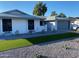 Attractive single-story home with manicured lawn and updated gray exterior paint and garage door at 4007 W Rue De Lamour Ave, Phoenix, AZ 85029